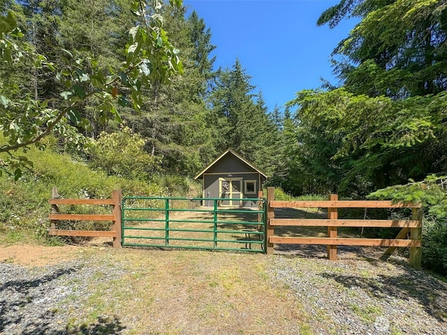 325 Evergreen View Pkwy, Port Angeles, WA 98363 - view of gate with a forest view and an outdoor structure