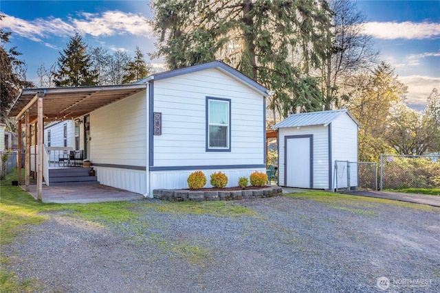 3001 S 288th St Unit 282, Federal Way, WA 98003 - view of front of home featuring an outbuilding, fence, a gate, and a storage unit