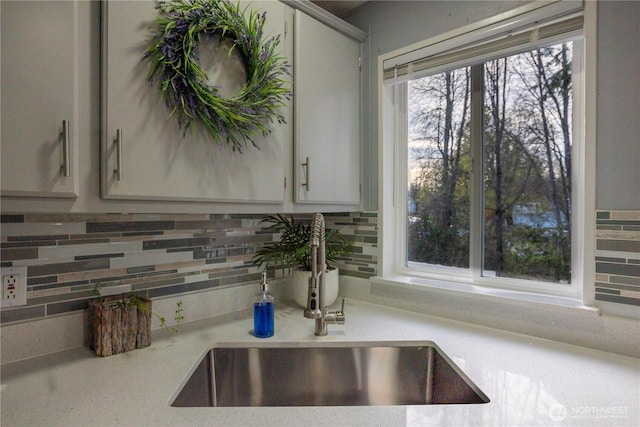 3001 S 288th St Unit 282, Federal Way, WA 98003 - details featuring light countertops, a sink, and decorative backsplash