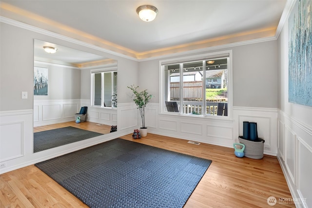 1716 7th St SE, Puyallup, WA 98372 - workout area with wood finished floors, wainscoting, visible vents, and a decorative wall