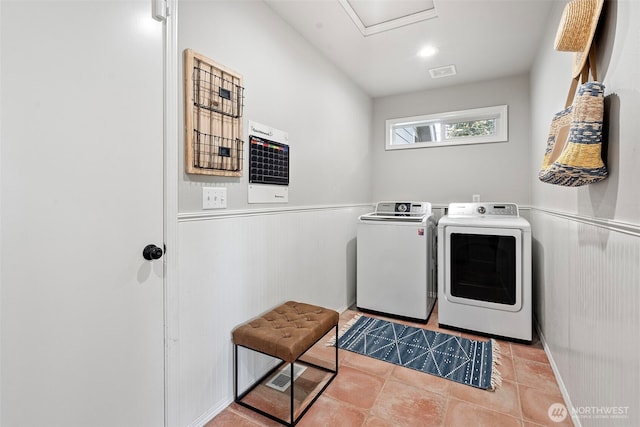 1716 7th St SE, Puyallup, WA 98372 - washroom featuring tile patterned flooring, wainscoting, laundry area, visible vents, and washing machine and clothes dryer