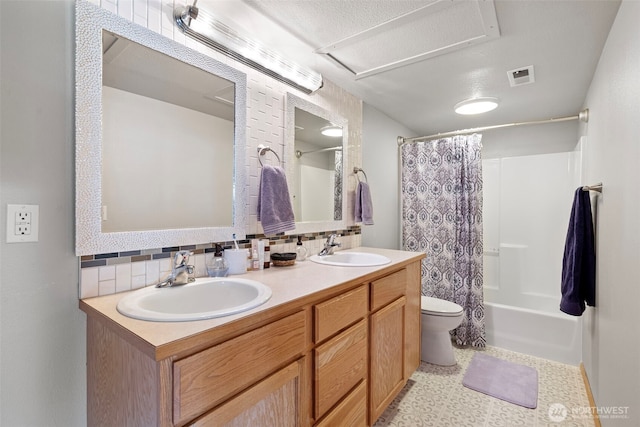 1716 7th St SE, Puyallup, WA 98372 - bathroom with toilet, a sink, and backsplash