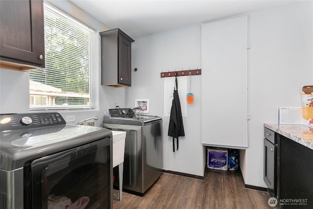 laundry room with baseboards, cabinet space, independent washer and dryer, and dark wood-style floors