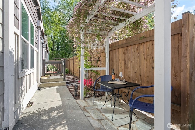 view of patio / terrace featuring fence and a pergola