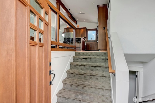staircase featuring recessed lighting and lofted ceiling