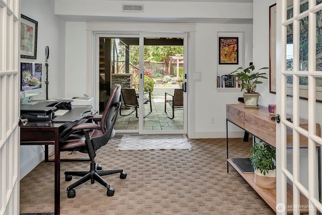 office area featuring visible vents, baseboards, and carpet
