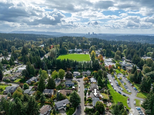 drone / aerial view featuring a forest view