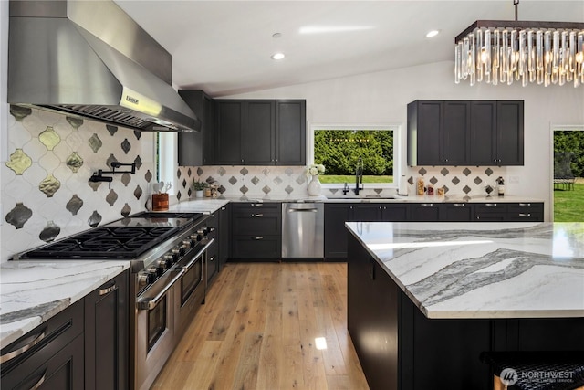 12425 318th Ave NE, Duvall, WA 98019 - kitchen with wall chimney exhaust hood, appliances with stainless steel finishes, a sink, light stone countertops, and tasteful backsplash