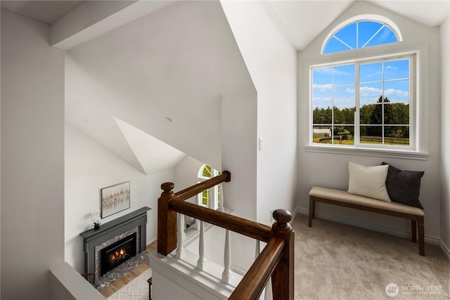 12425 318th Ave NE, Duvall, WA 98019 - staircase featuring lofted ceiling, carpet, a lit fireplace, and baseboards