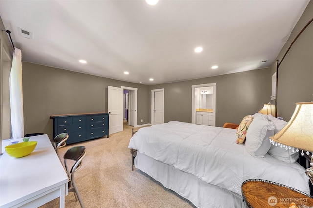 bedroom with connected bathroom, recessed lighting, and light colored carpet