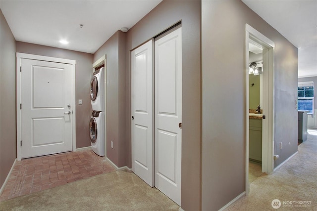10549 Stone Ave N Unit 103, Seattle, WA 98133 - hall with estacked washer and dryer, light colored carpet, and brick patterned flooring