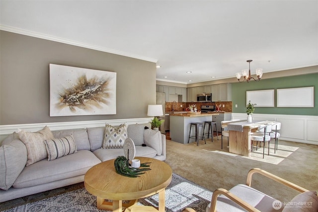 10549 Stone Ave N Unit 103, Seattle, WA 98133 - living room with a chandelier, crown molding, light carpet, wainscoting, and recessed lighting