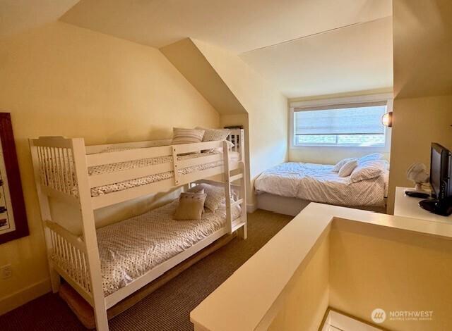 bedroom with lofted ceiling and carpet floors