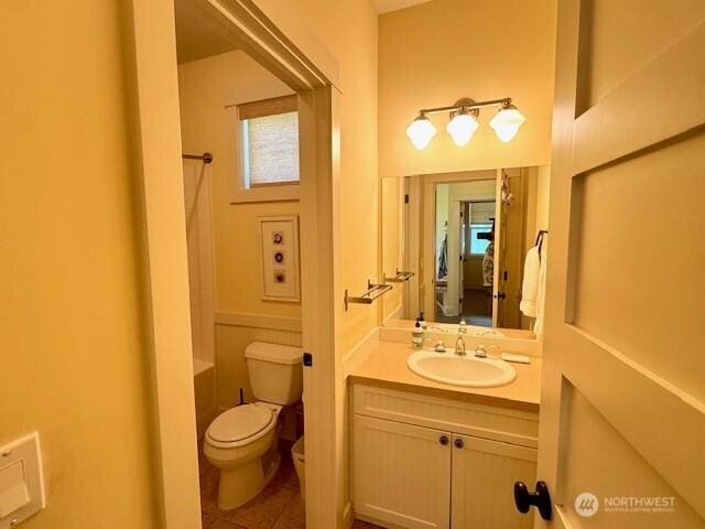bathroom with toilet, shower / bathtub combination, tile patterned floors, and vanity