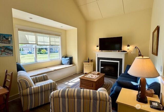 living room with a fireplace and lofted ceiling
