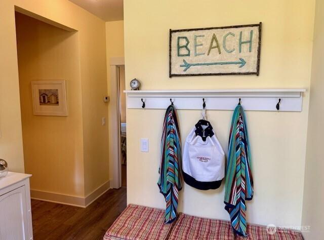 mudroom with dark wood-type flooring and baseboards