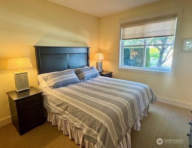 carpeted bedroom featuring baseboards