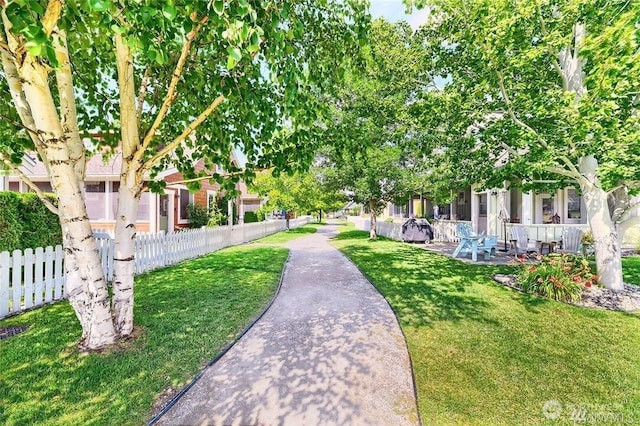 view of home's community featuring a yard and fence