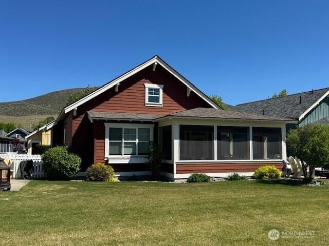 103 Shenanigan Ln, Oroville, WA 98844 - exterior space featuring a yard, a sunroom, and a mountain view