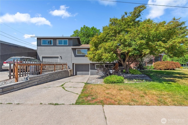 26 Pershing St, Wenatchee, WA 98801 - view of front facade featuring a garage, concrete driveway, and a front lawn