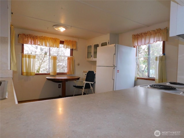 18329 32nd Ave S, Seatac, WA 98188 - kitchen with freestanding refrigerator, glass insert cabinets, white cabinets, and electric range