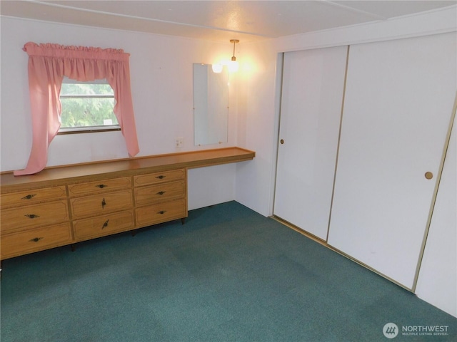 18329 32nd Ave S, Seatac, WA 98188 - unfurnished bedroom with built in desk, dark colored carpet, and a closet