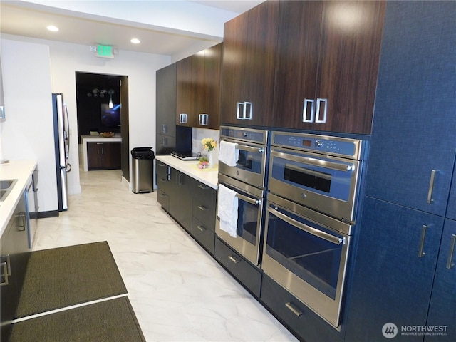 18329 32nd Ave S, Seatac, WA 98188 - kitchen featuring recessed lighting, marble finish floor, modern cabinets, light countertops, and appliances with stainless steel finishes