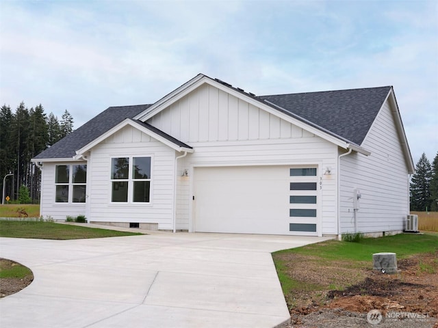 303 Kakela Rd, Winlock, WA 98596 - view of front of property with a shingled roof, driveway, a garage, and cooling unit
