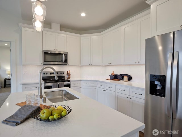 303 Kakela Rd, Winlock, WA 98596 - kitchen featuring stainless steel appliances, white cabinets, decorative backsplash, light countertops, and recessed lighting