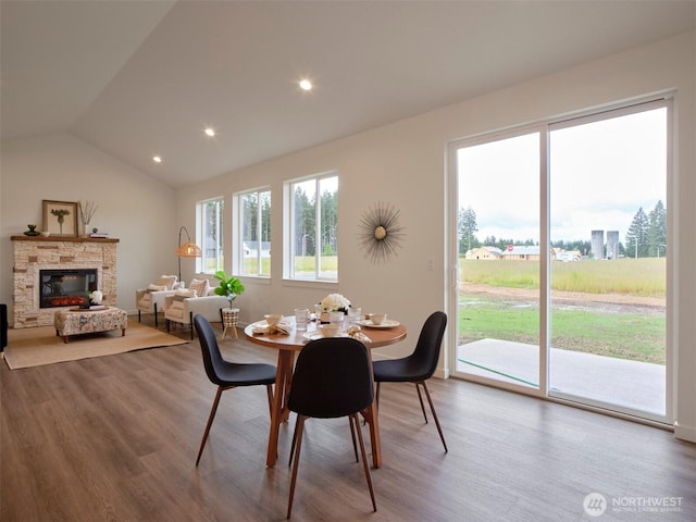 303 Kakela Rd, Winlock, WA 98596 - dining area featuring wood finished floors, lofted ceiling, a stone fireplace, and recessed lighting
