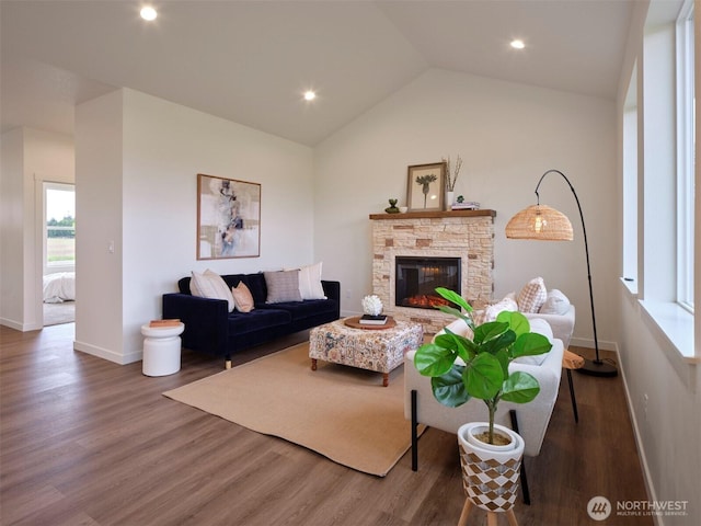 303 Kakela Rd, Winlock, WA 98596 - living area with wood finished floors, baseboards, a fireplace, lofted ceiling, and recessed lighting