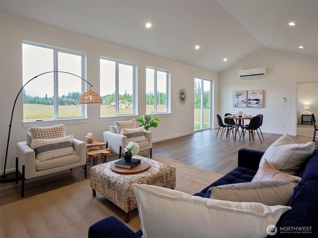 303 Kakela Rd, Winlock, WA 98596 - living area with a wall unit AC, wood finished floors, lofted ceiling, recessed lighting, and baseboards