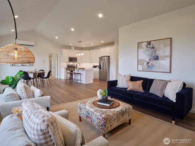303 Kakela Rd, Winlock, WA 98596 - living room with light wood-style floors, recessed lighting, vaulted ceiling, and a wall mounted AC