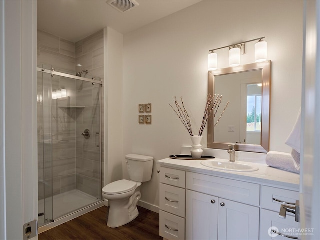 303 Kakela Rd, Winlock, WA 98596 - full bathroom featuring toilet, vanity, a stall shower, and wood finished floors