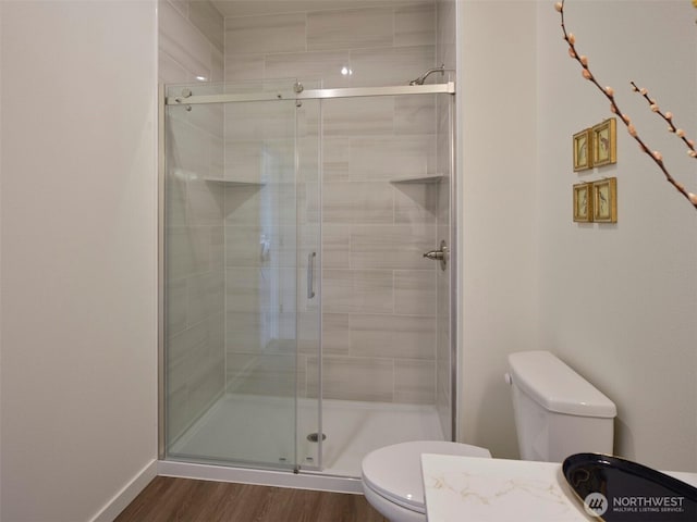 303 Kakela Rd, Winlock, WA 98596 - bathroom with toilet, a shower stall, wood finished floors, and baseboards