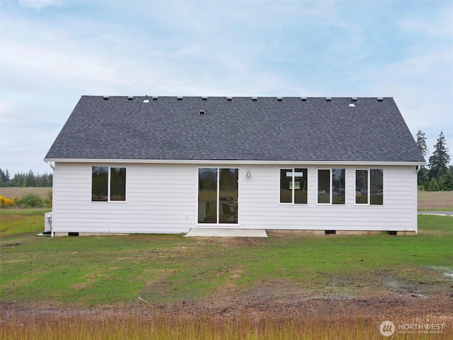 303 Kakela Rd, Winlock, WA 98596 - back of property featuring crawl space, a lawn, a patio area, and roof with shingles