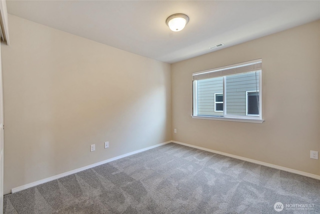 carpeted empty room featuring visible vents and baseboards
