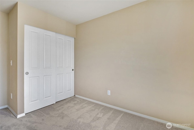 unfurnished bedroom featuring carpet and baseboards