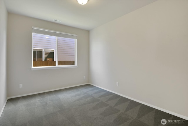 empty room with visible vents, baseboards, and carpet flooring