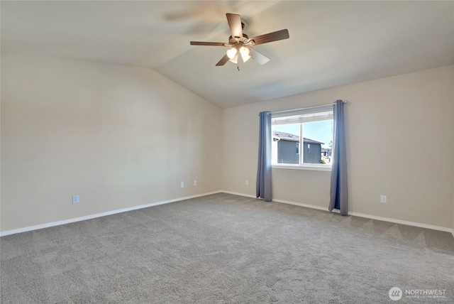 unfurnished room with ceiling fan, vaulted ceiling, carpet floors, and baseboards