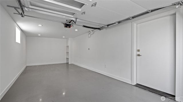 garage with recessed lighting, baseboards, and a garage door opener