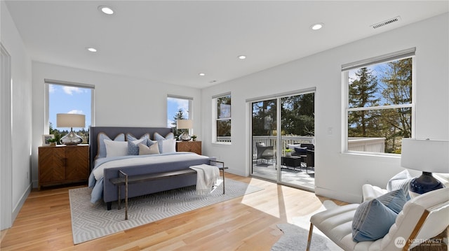 bedroom with visible vents, access to exterior, and multiple windows