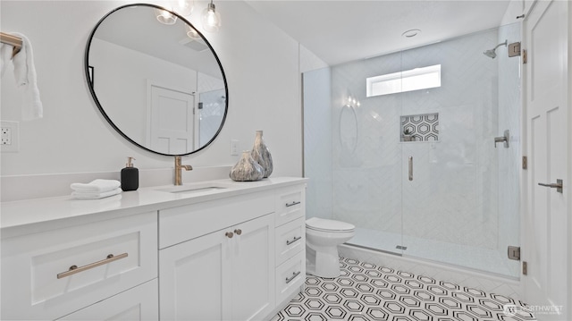 full bathroom featuring tile patterned flooring, toilet, a shower stall, and vanity