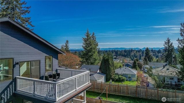 deck featuring a mountain view and fence