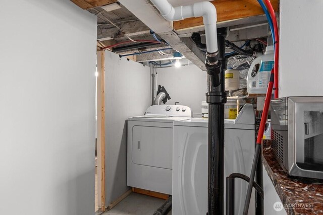 washroom featuring separate washer and dryer and laundry area