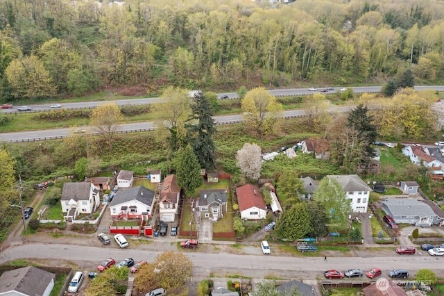 bird's eye view with a wooded view and a residential view