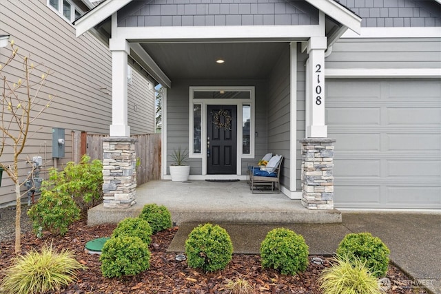 2108 173rd Street Ct E, Spanaway, WA 98387 - view of exterior entry featuring a porch, an attached garage, and stone siding