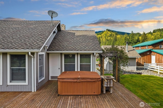 7095 N Wilde Rd, Concrete, WA 98237 - back of house featuring a hot tub, a wooden deck, a chimney, and roof with shingles