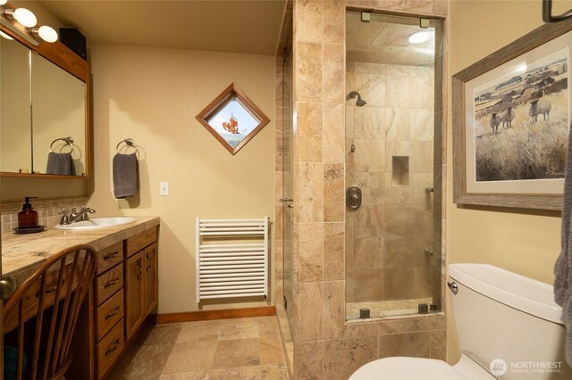 7095 N Wilde Rd, Concrete, WA 98237 - full bathroom featuring toilet, a stall shower, radiator heating unit, baseboards, and vanity