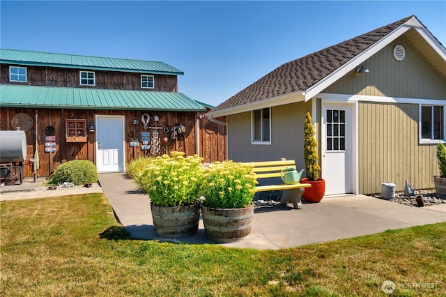 7095 N Wilde Rd, Concrete, WA 98237 - back of house with oil tank, a yard, and metal roof